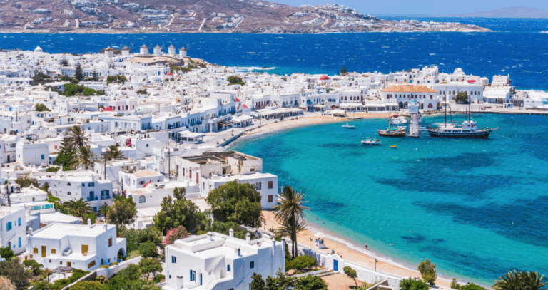 a beautiful vista of Greece, showing an archipelago with lots of white buildings reaching out to the ocean