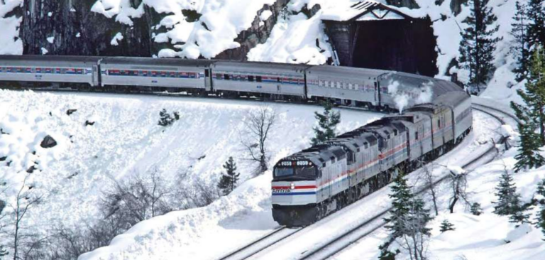 A train going through a snowy mountain pass